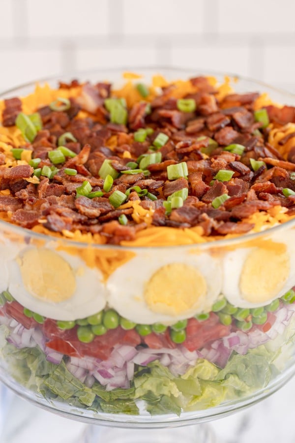 7 layer salad in a glass bowl.