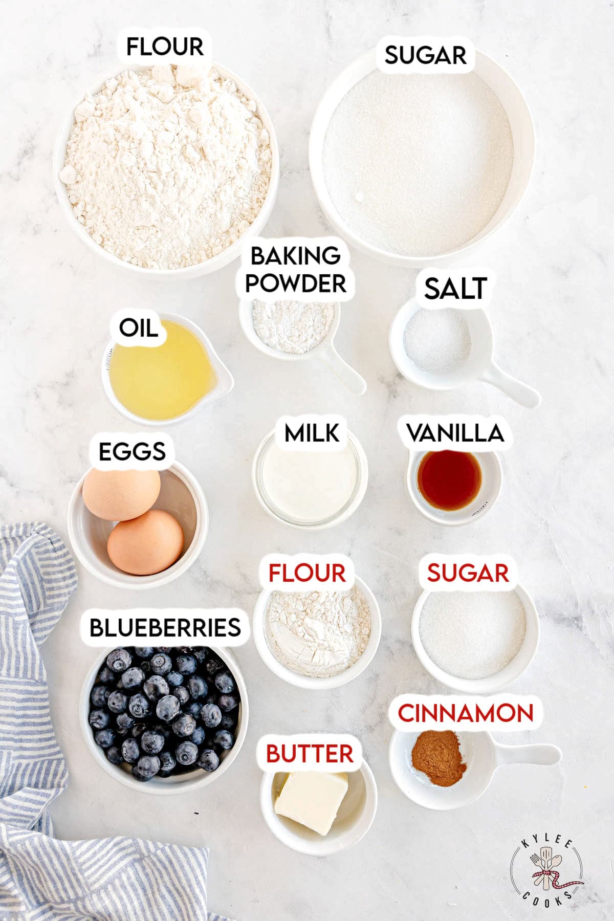 ingredients to make blueberry muffins laid out and labeled.