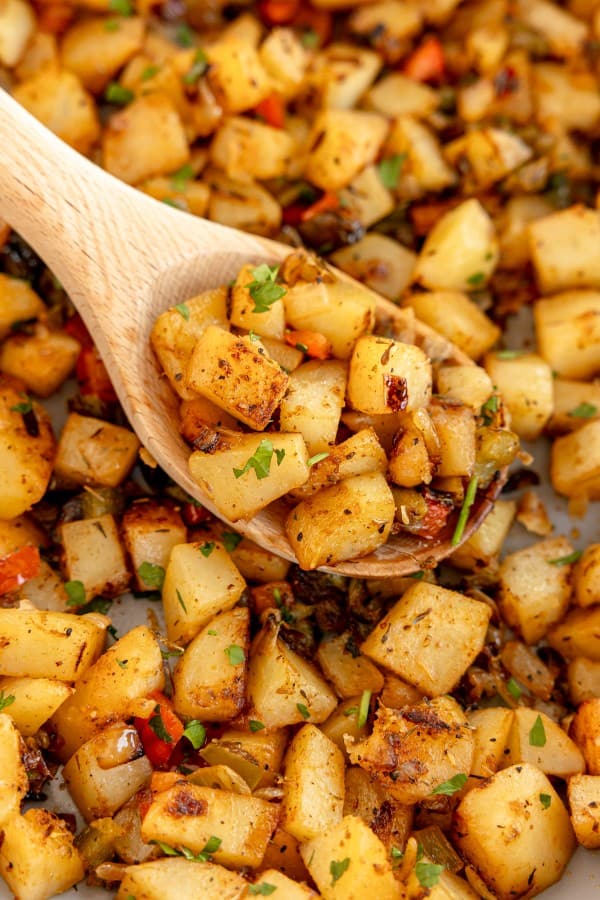 breakfast potatoes on a wooden spoon.