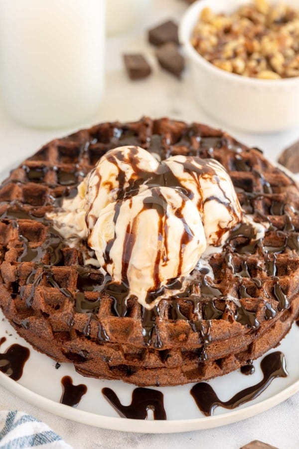 stack of chocolate waffles with icecream and syrup.