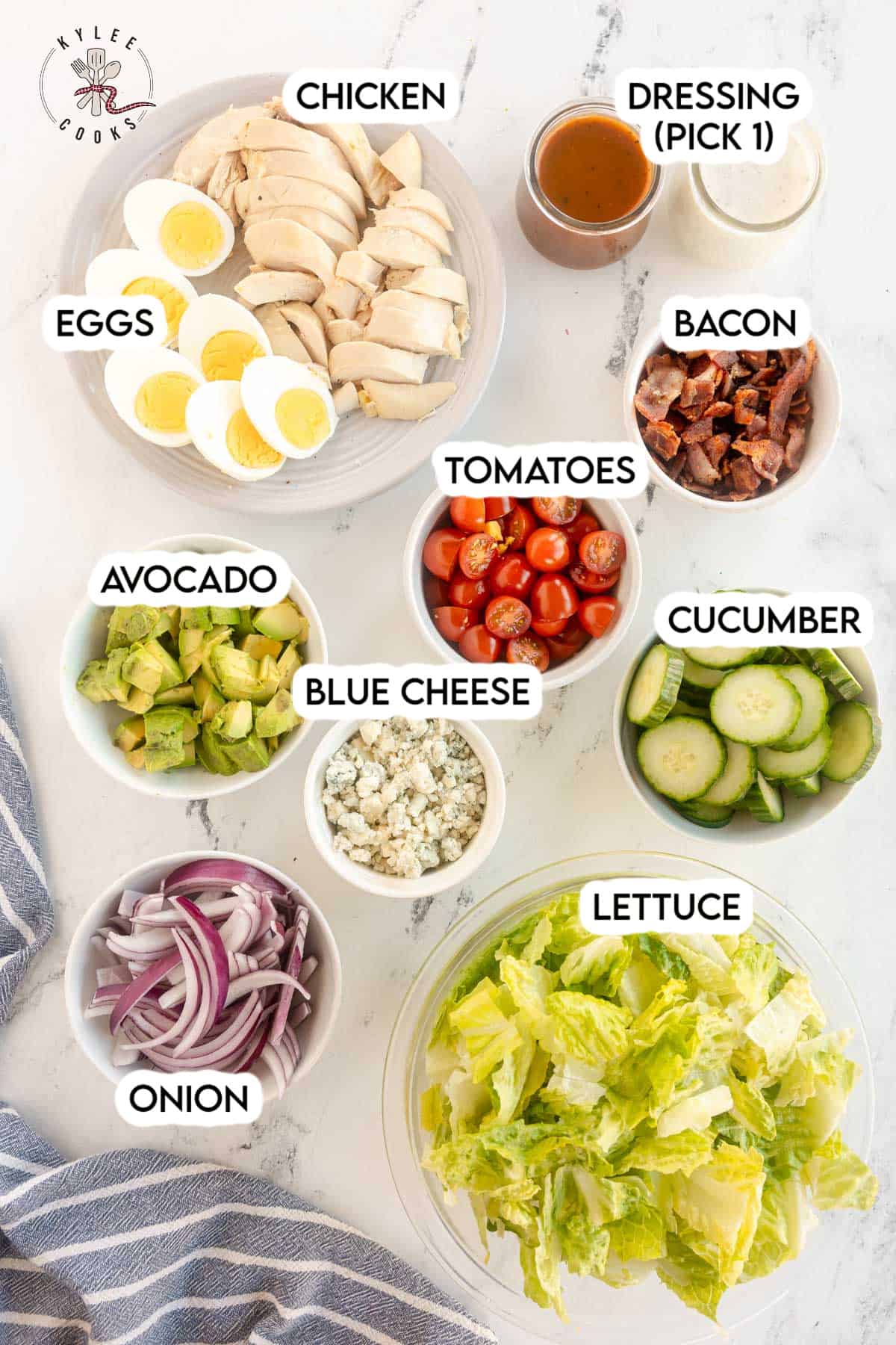 A group of bowls of Cobb Salad and chicken.