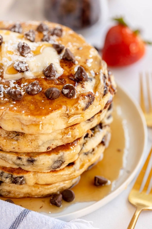 chocolate chip pancake stack on white plate.