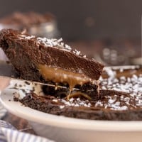 slice of chocolate tart being lifted out of a pie plate.