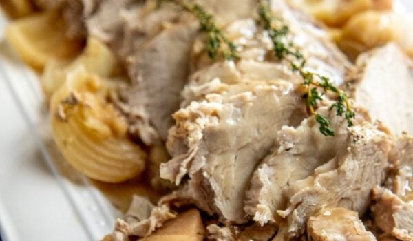 Crockpot pork loin on a white platter