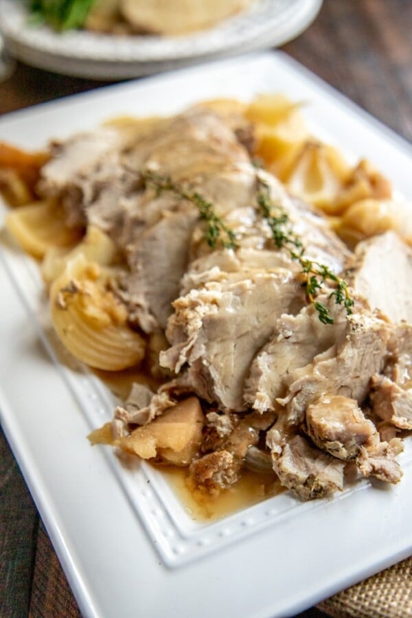 Crockpot pork loin on a white platter