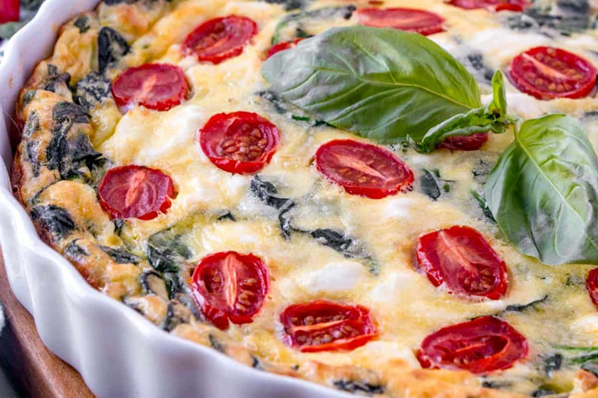 crustless spinach quiche in a white tart pan.