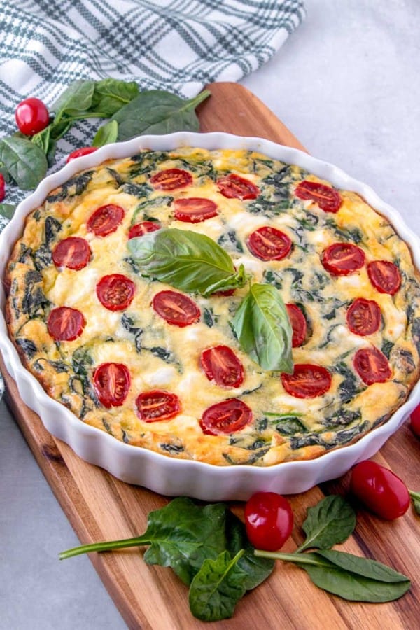 crustless spinach quiche in a white tart pan.