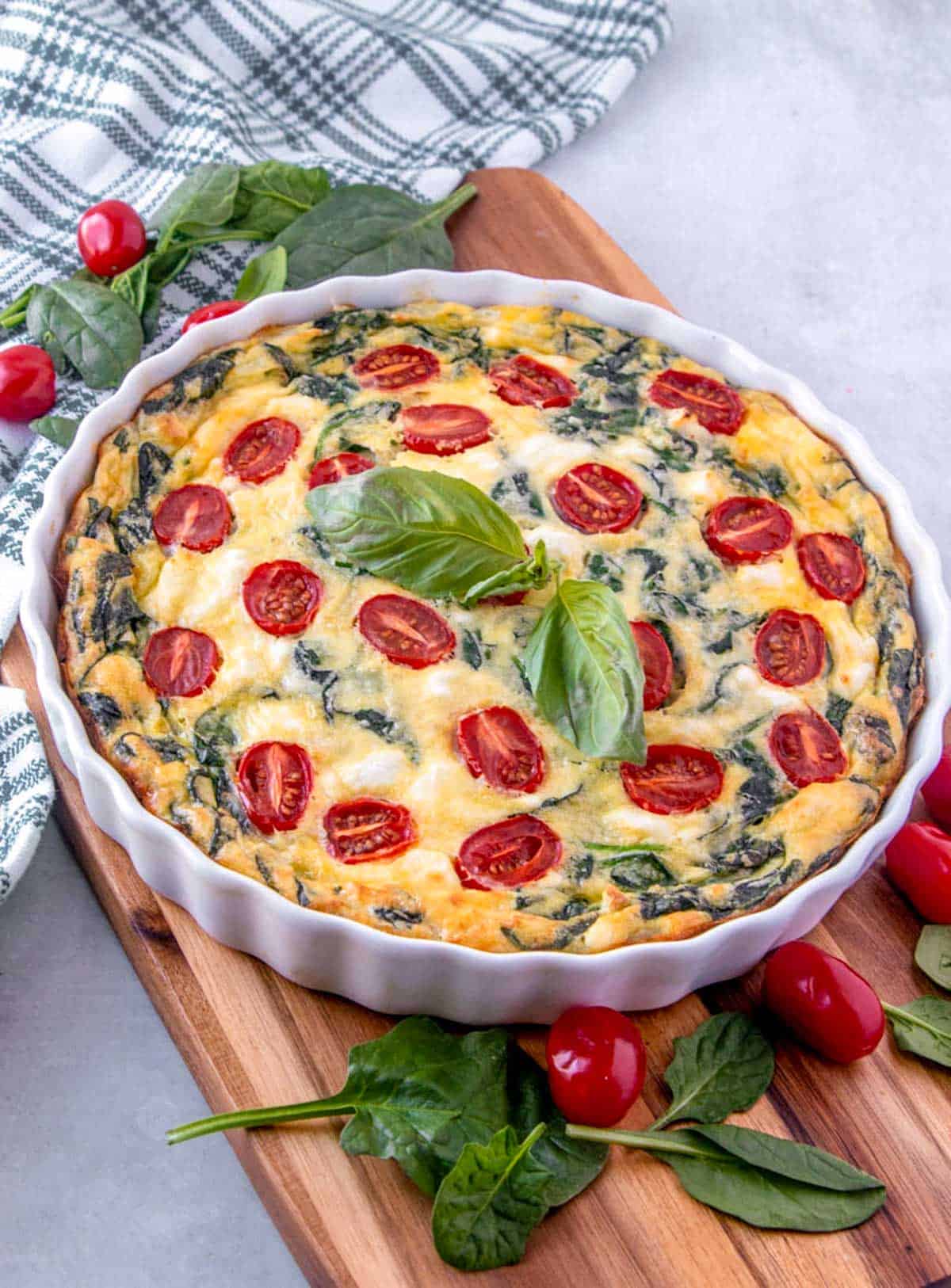 crustless spinach quiche in a white tart pan.