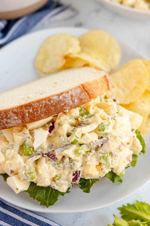 egg salad in a sandwich with lettuce.