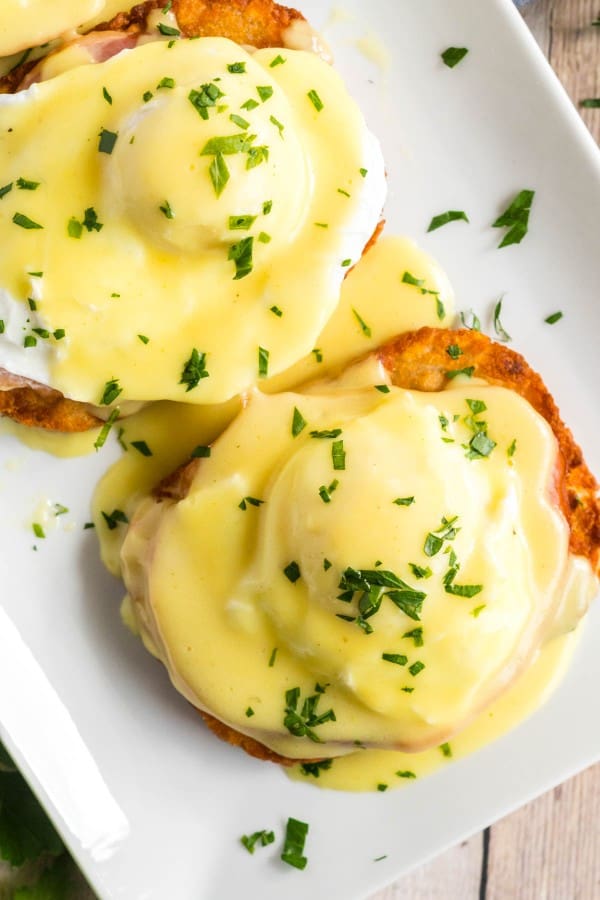 eggs benedict on a white platter