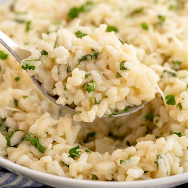 Creamy garlic parmesan risotto garnished with herbs.
