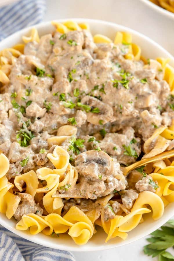 Ground beef stroganoff served in a white bowl.