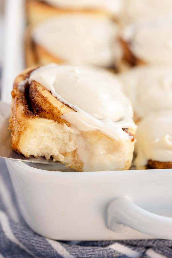 a cinnamon roll in a white baking dish.