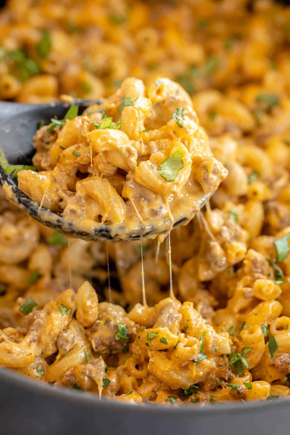 cheeseburger pasta close up on a ladle.