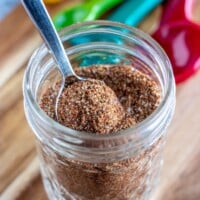 taco seasoning in a glass jar with a spoon