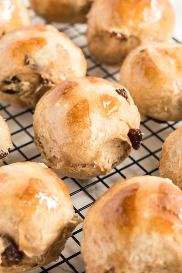 hot cross buns on a cooling rack.