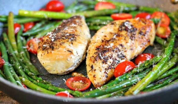 chicken with green beans and tomatoes in a skillet