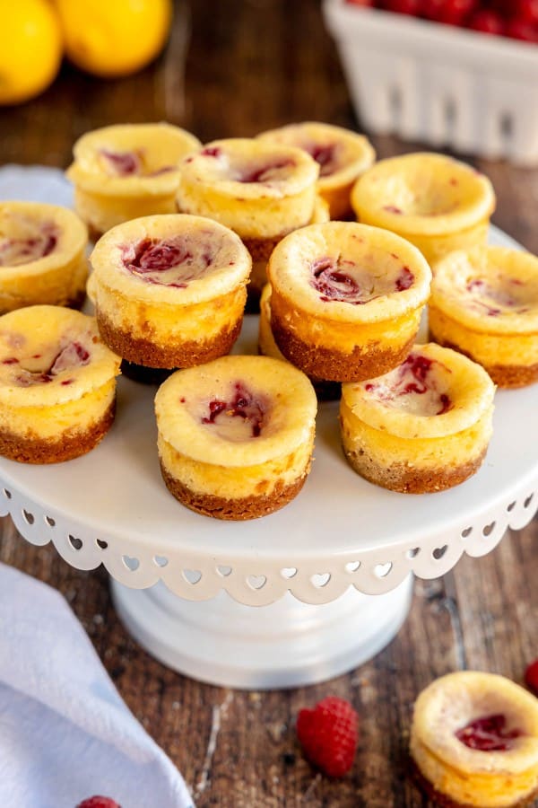 mini lemon cheesecakes with berry swirl on a cake stand