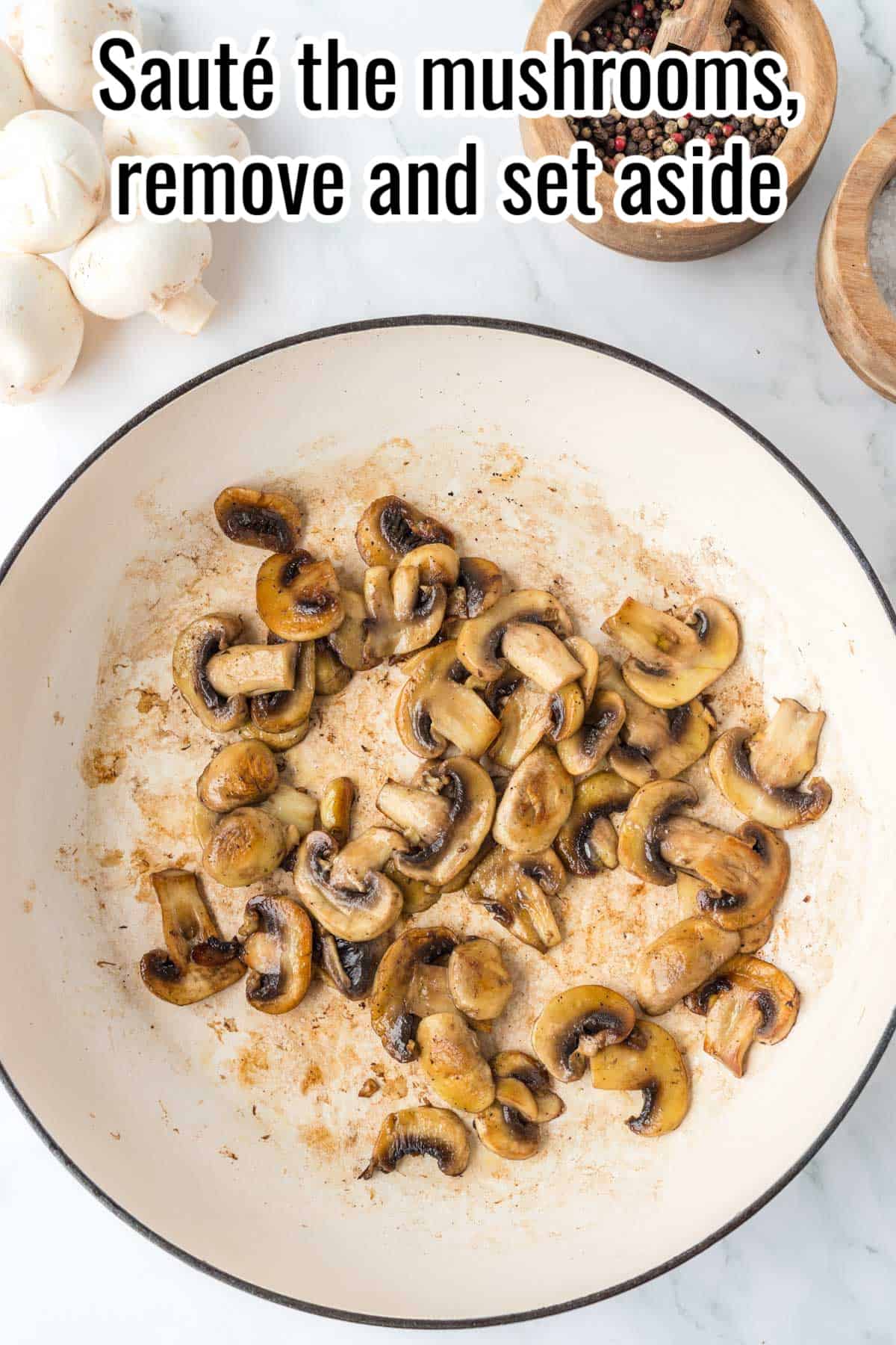 A skillet with sauteed mushrooms in it.
