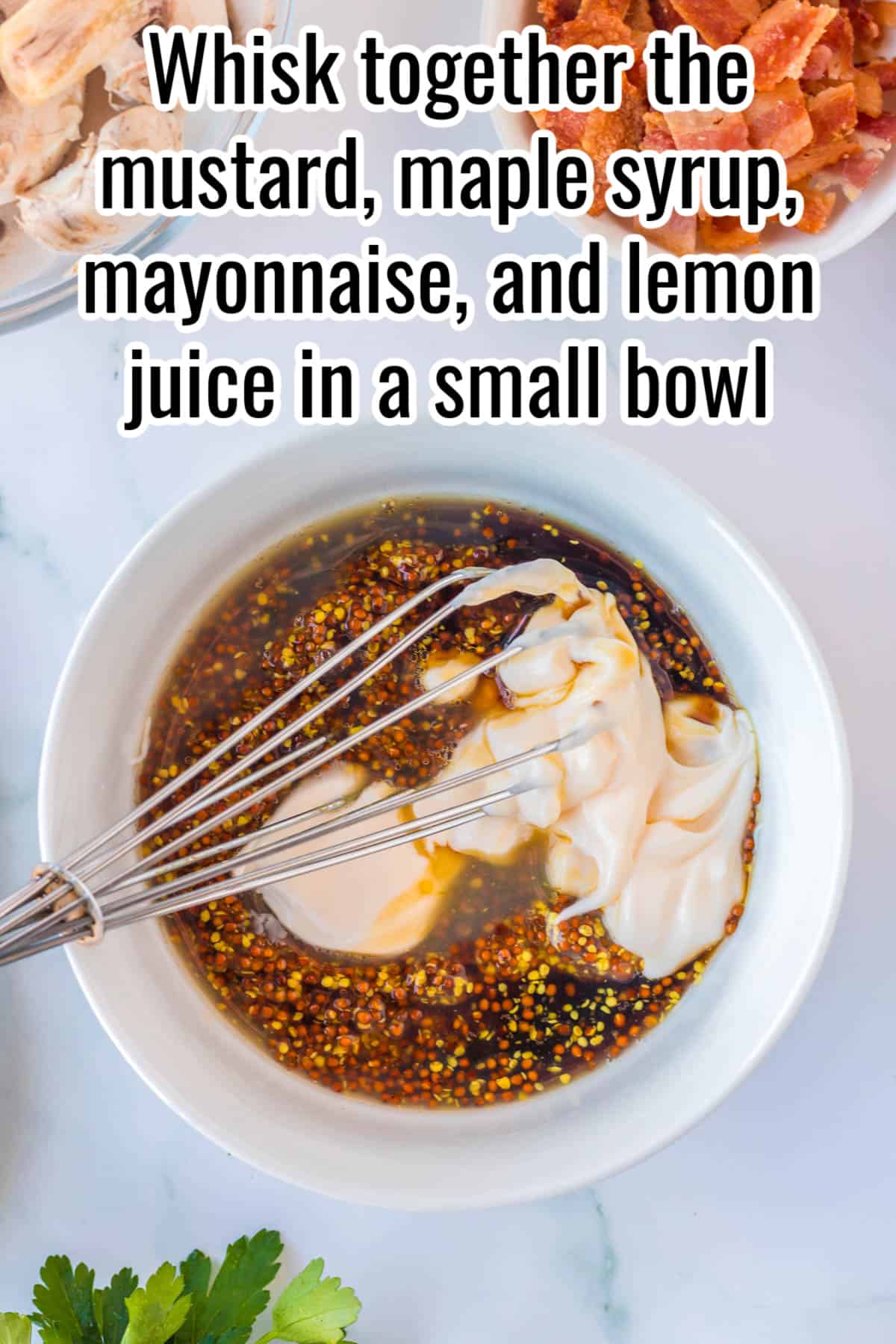 A bowl with ingredients for marinating chicken and a whisk.
