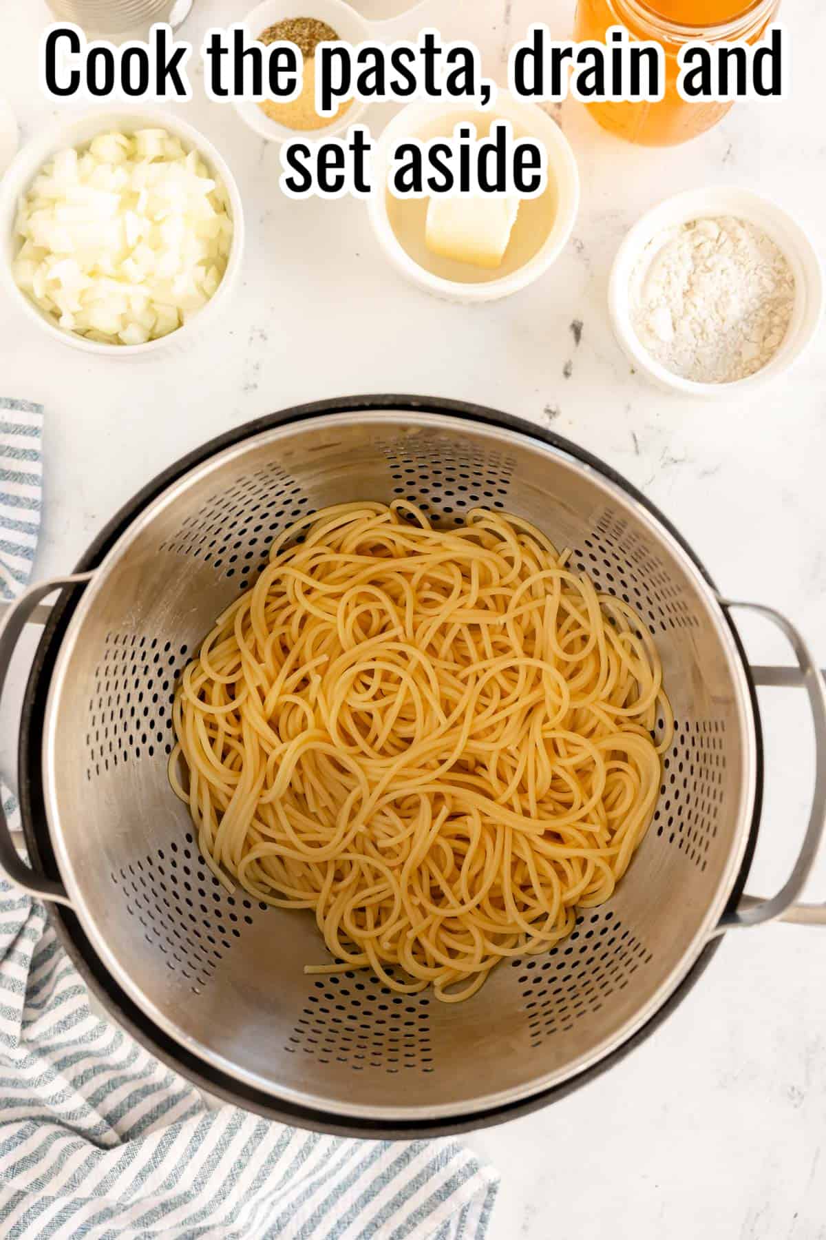 a colander with drained spaghetti in it.