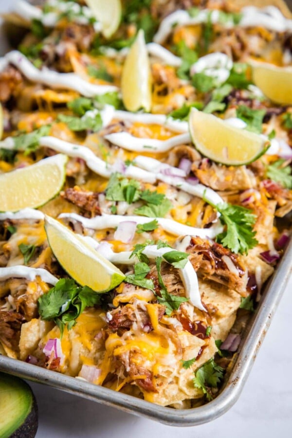 pulled pork nachos on a baking sheet