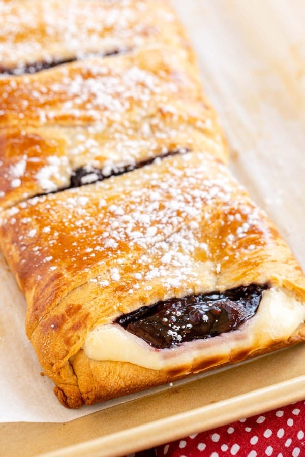 A raspberry-filled danish topped with powdered sugar.