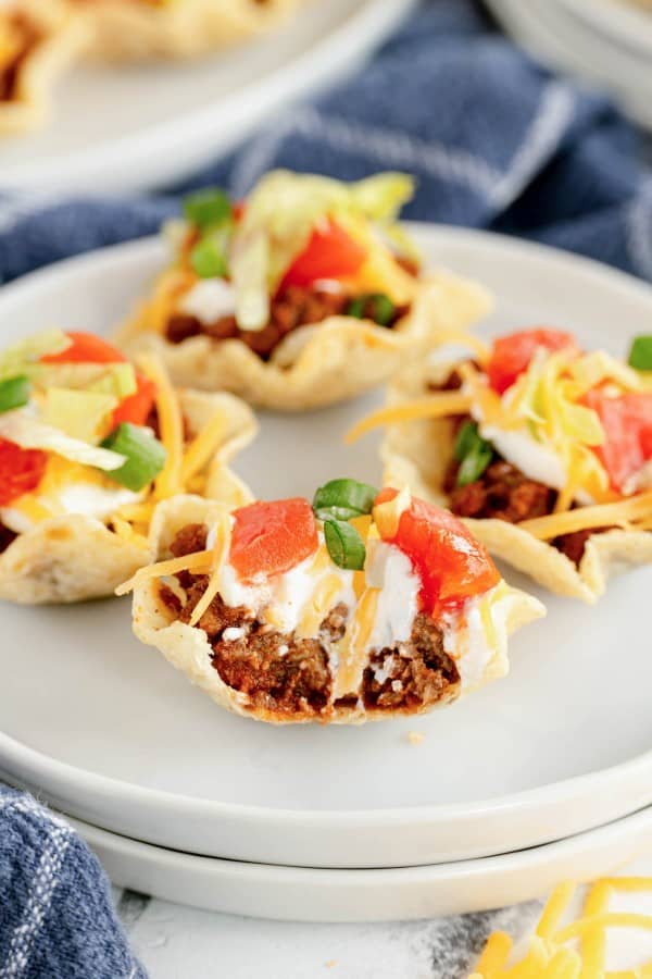 a mini taco bite with showing the inside after someone took a bite.