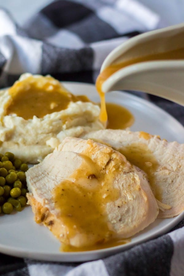 turkey gravy being poured over turkey slices.