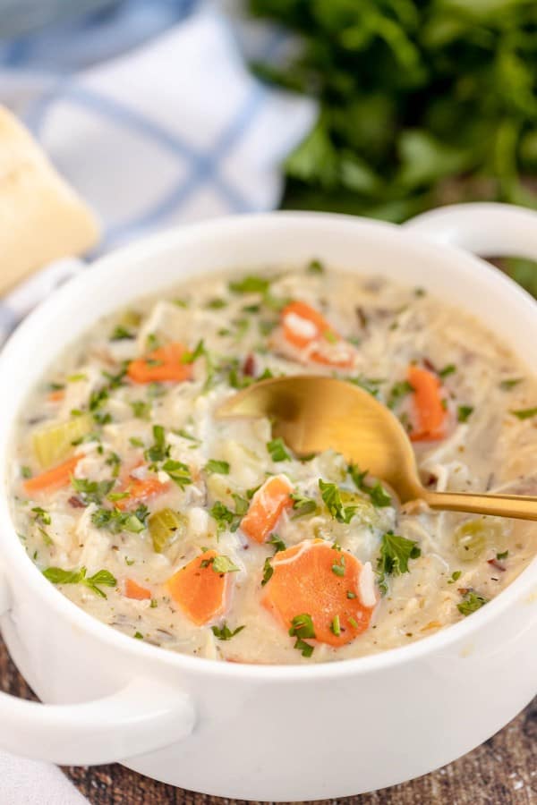 turkey rice soup in a white bowl.