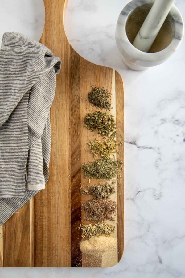 tuscan seasoning ingredients laid out on a chopping board